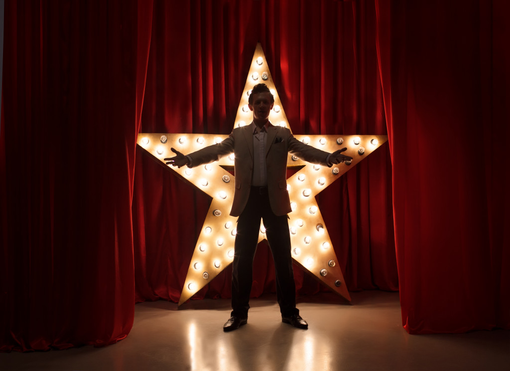 theatre actor onstage with a glowing star in the background
