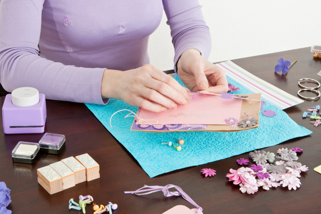 a woman creating pieces for scrapbooks